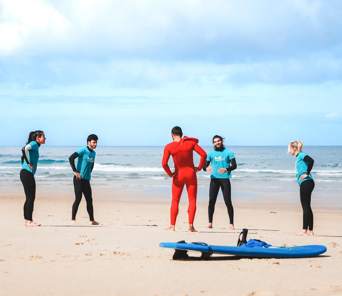Nazare Surf School instructor briefing a group of students on the beach before a lesson